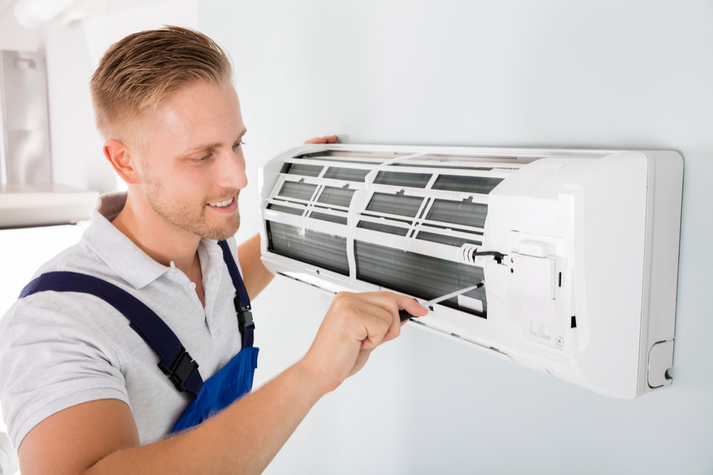HVAC technician maintaining a ductless air conditioner in West Sacramento