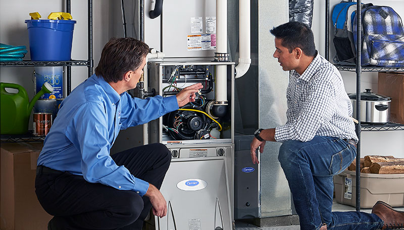 Technician evaluating a furnace for repair or replacement in West Sacramento