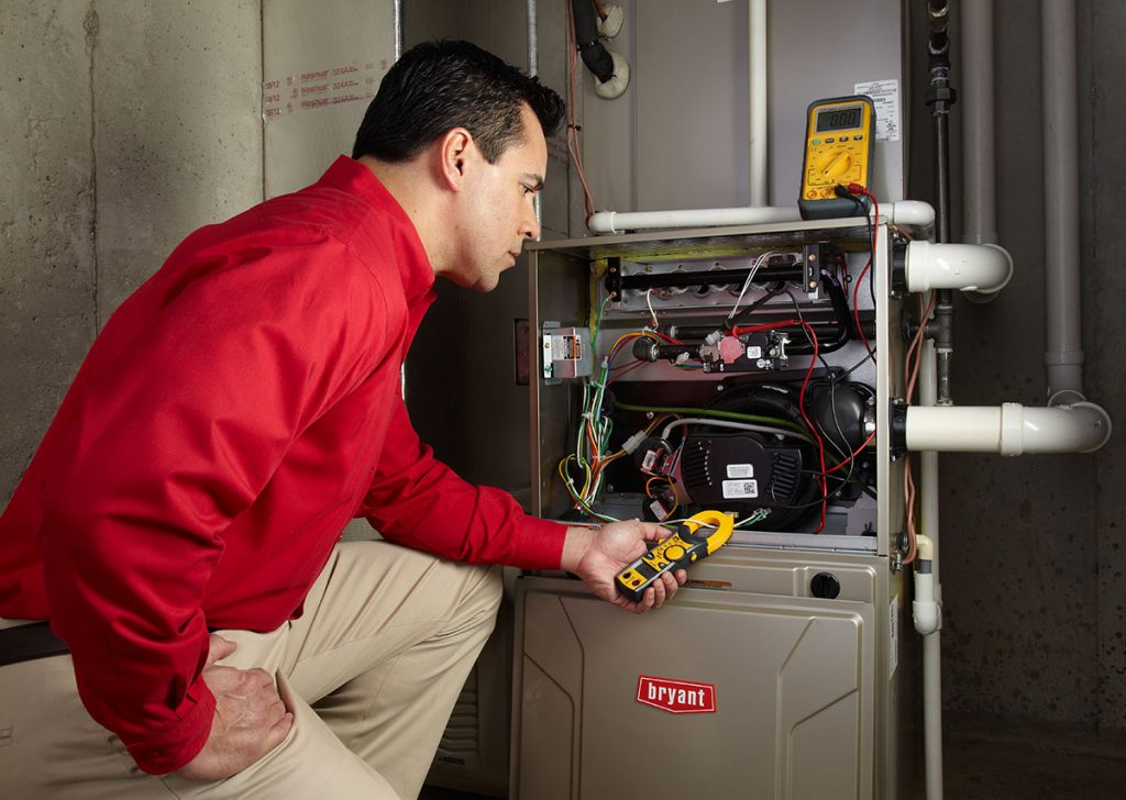 Heating technician diagnosing a furnace repair in West Sacramento