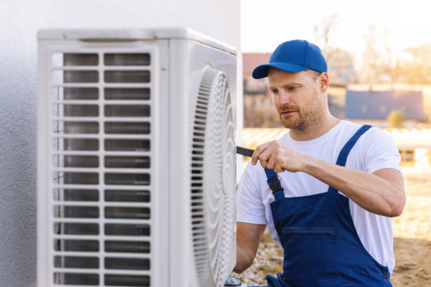 HVAC technician servicing an outdoor air conditioner in West Sacramento