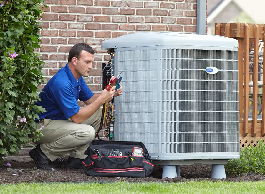 HVAC technician inspecting an outdoor AC unit in West Sacramento